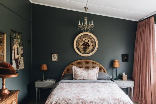 a bedroom with a bed and a painting on the wall at Seymour House in Moss Vale