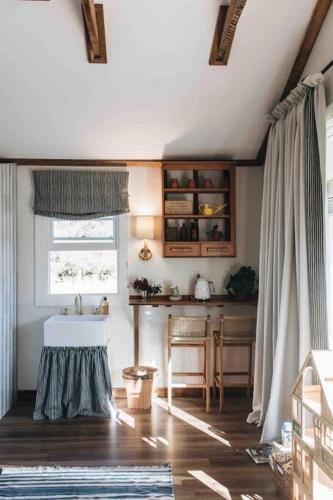 a living room with a table and a window at Seymour House in Moss Vale