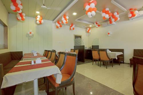 a dining room with tables and chairs and balloons at Hotel O Anuha Mumbai in Mumbai
