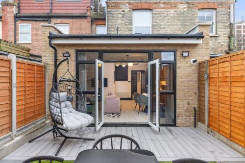 a patio with sliding glass doors on a building at Unwind in Style 2BR with Cozy Backyard for Groups in London