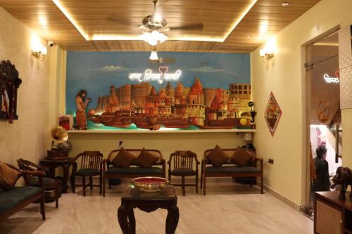 a waiting room with a painting on the wall at Satshree Kothi in Varanasi
