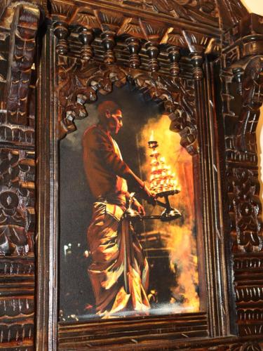 a framed painting of a man holding a chessboard at Satshree Kothi in Varanasi
