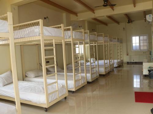 a row of bunk beds in a room at Satshree Kothi in Varanasi