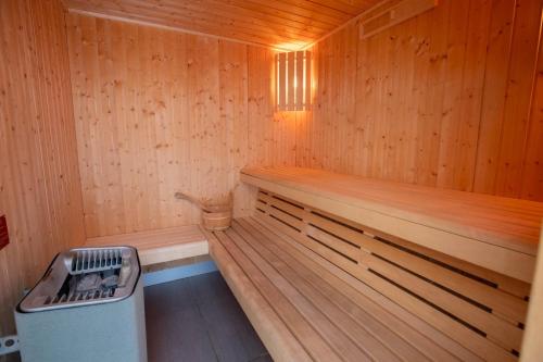 un sauna avec un banc et une poubelle dans l'établissement Chalet in méribel center with outdoor jacuzzi and sauna, à Mussillon