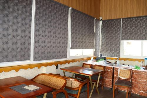 a restaurant with tables and chairs and a counter at Satshree Kothi in Varanasi