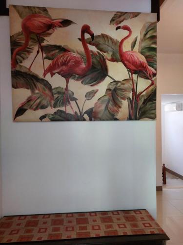 a painting of pink flamingos on a wall at Yuken Mari Beach Resort Panglao in Panglao