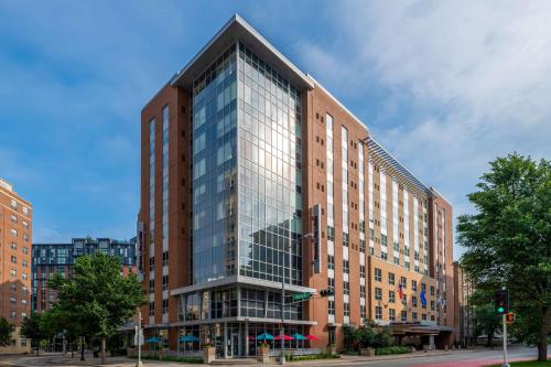 a tall glass building on a city street at Hampton Inn & Suites Madison Downtown in Madison
