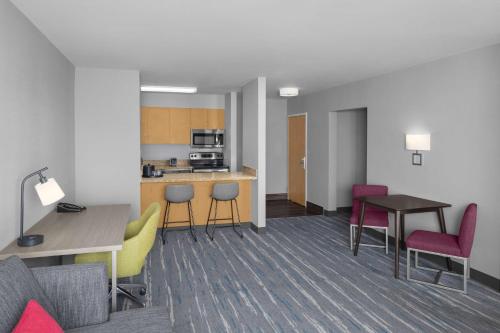 a living room with a table and chairs and a kitchen at Hampton Inn & Suites Orem/Provo in Orem