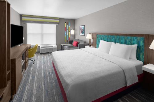 a hotel room with a large bed and a television at Hampton Inn & Suites Orem/Provo in Orem