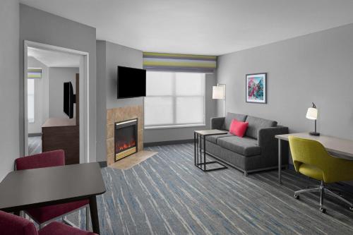 a living room with a couch and a fireplace at Hampton Inn & Suites Orem/Provo in Orem