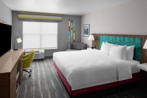 a hotel room with a bed and a desk at Hampton Inn & Suites Orem/Provo in Orem