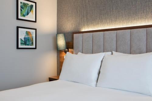 a hotel room with a bed with white pillows at DoubleTree by Hilton London Chelsea in London