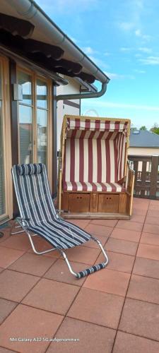 two beach chairs sitting on a patio on a roof at Residenz Seestern Ws 08 in Kühlungsborn