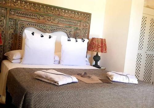 a bedroom with a bed with two towels on it at Il Baglio sull'Acqua in Favignana