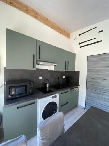 a kitchen with a microwave and a dishwasher at STUDIO des Lacs in Puttelange-aux-Lacs