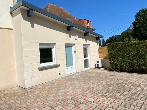 a house with a garage and a brick driveway at STUDIO des Lacs in Puttelange-aux-Lacs
