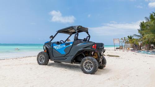 a golf cart parked on the beach at Sands Inn Hotel in Pwani Mchangani