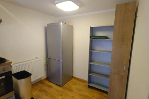 a kitchen with a refrigerator in a room at Apartment 4 Zum Kuhstall Heinrichsberg - Magdeburg in Niegripp
