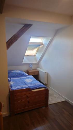 a bedroom with a bed in a attic at Apartment 4 Zum Kuhstall Heinrichsberg - Magdeburg in Niegripp