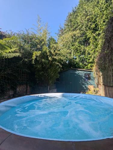 a large blue swimming pool in a yard at House in historic Winchester in Winchester