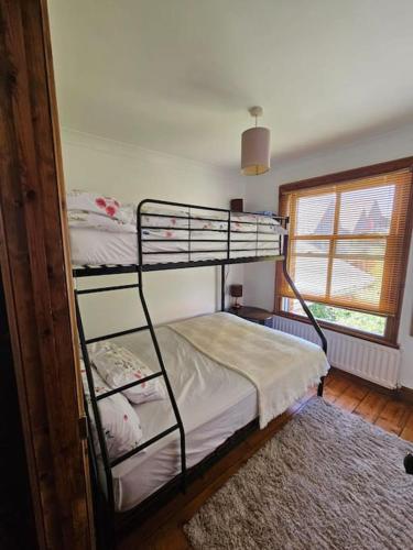 a bedroom with two bunk beds and a window at House in historic Winchester in Winchester