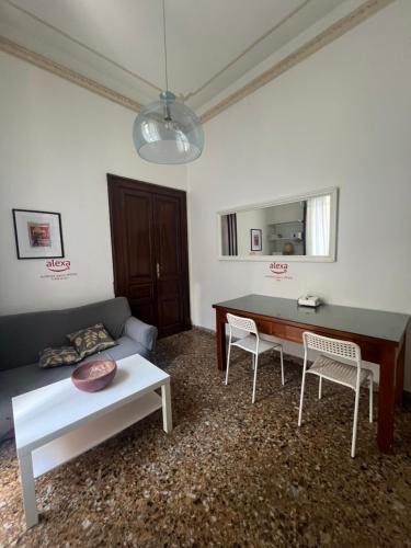 a living room with a couch and a table and chairs at Mylittlehouse in Messina