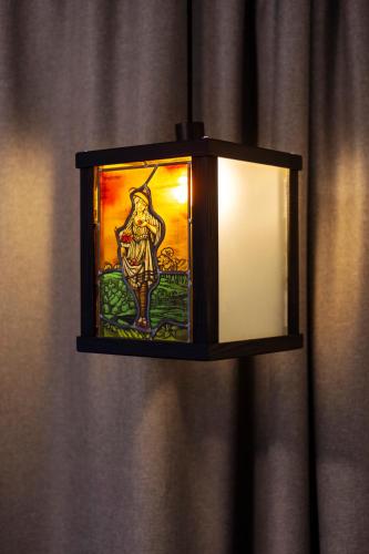 a lantern with a picture of a deity on it at schlossmühle - lean luxury boutique hotel in Glottertal