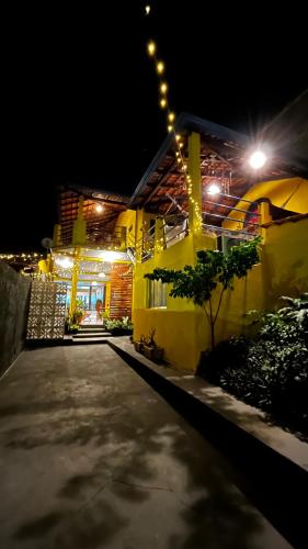 a house lit up at night with lights on it at Casa da Vila - Hospedaria - 3 min do centrinho de Alter in Alter do Chao