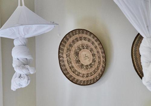 a plate hanging on a wall next to a curtain at Palacina The Residence & The Suites in Nairobi