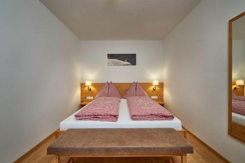 a bedroom with two beds with red pillows at Berg- & Seeblick Pfefferbauer in Zell am See