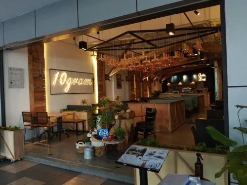 a restaurant with tables and chairs in a room at Vista Alam P Big Studio in Shah Alam