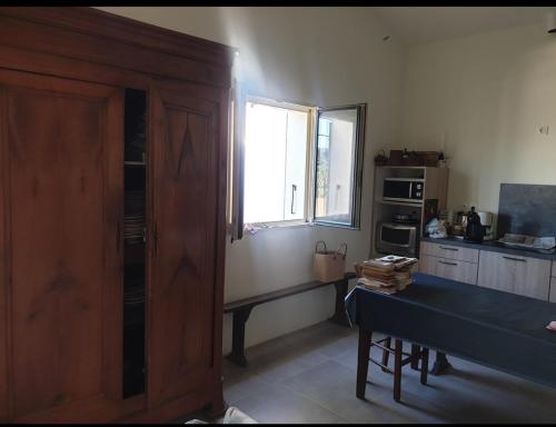 - une cuisine avec une table et une fenêtre dans une chambre dans l'établissement Maison de famille, à Montséret