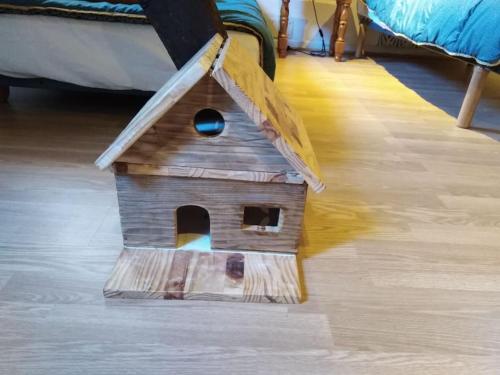 a wooden bird house sitting on the floor at Maison de montagne, vallée d'Ossau in Bielle