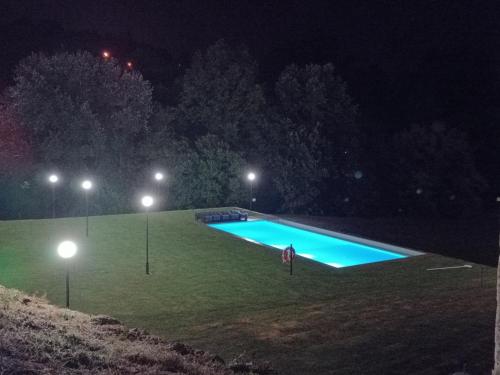 a swimming pool in a field at night at Rilhadas Casas de Campo in Fafe