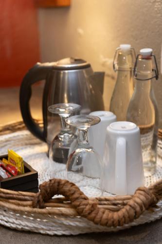 a table with a tray with a coffee pot and a rope at Wasabi in Canggu
