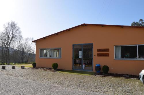 a building with a blue door on the side of it at Rilhadas Casas de Campo in Fafe