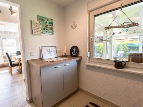 a kitchen with a counter and a window at Strand Haus in Loissin