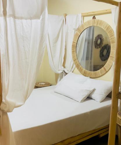 a bed with a mirror on top of it at villa Oasis Rouge Sable in Marrakech