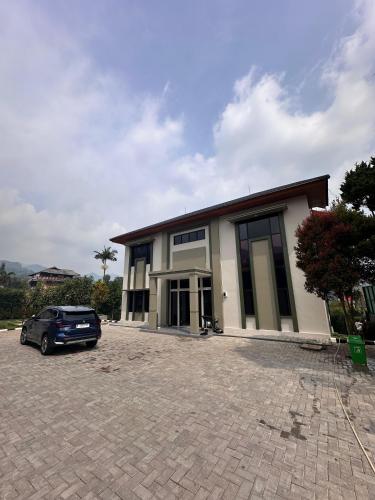 a car parked in front of a building at VILLA NEOM PUNCAk in Sampal 2