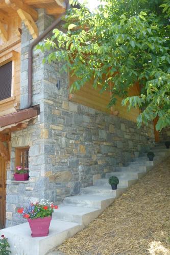 a stone wall with stairs leading up to a building at Chalet Helnes - chalet contemporain in Saint-Oyen