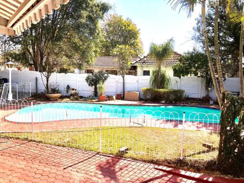 a fence in front of a swimming pool at Chapman Guesthouse in Pelham