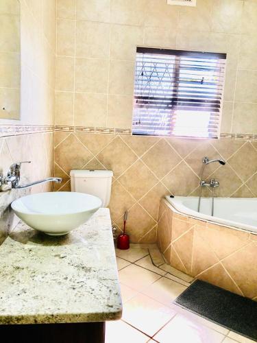 a bathroom with a sink and a toilet and a tub at Chapman Guesthouse in Pelham
