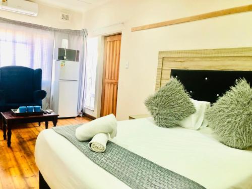 a bedroom with a large bed and a blue chair at Chapman Guesthouse in Pelham