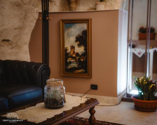 a living room with a couch and a table at Grotta Imperiale in Palagianello