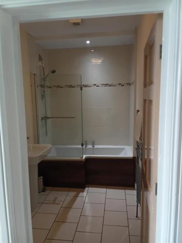 a bathroom with a bath tub and a sink at Foresters Guest House Ltd in Crook