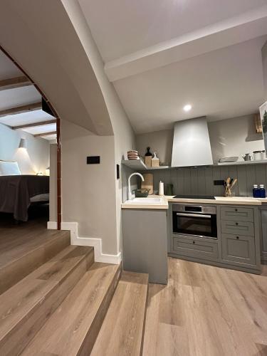 a kitchen with a sink and a stove top oven at Calendula Hotel & Apartaments in Sant Feliu de Guixols