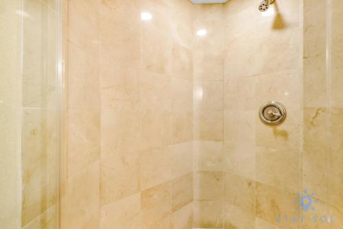 a shower stall with a glass shower door at Deluxe Studio Ocean View Premium Amenities in Sunny Isles Beach