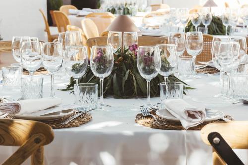 a table with wine glasses and plates and napkins at Casa del Médico Hotel Boutique in Alcázar de San Juan