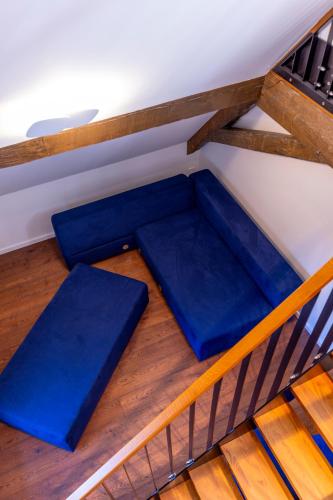 a room with blue cushions on the floor next to a staircase at schlossmühle - lean luxury boutique hotel in Glottertal