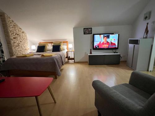 a living room with two beds and a flat screen tv at WiLLA APART in Władysławowo